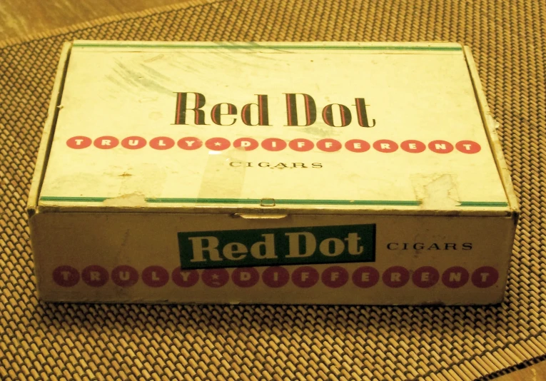 a red dot cigar box that is sitting on a chair