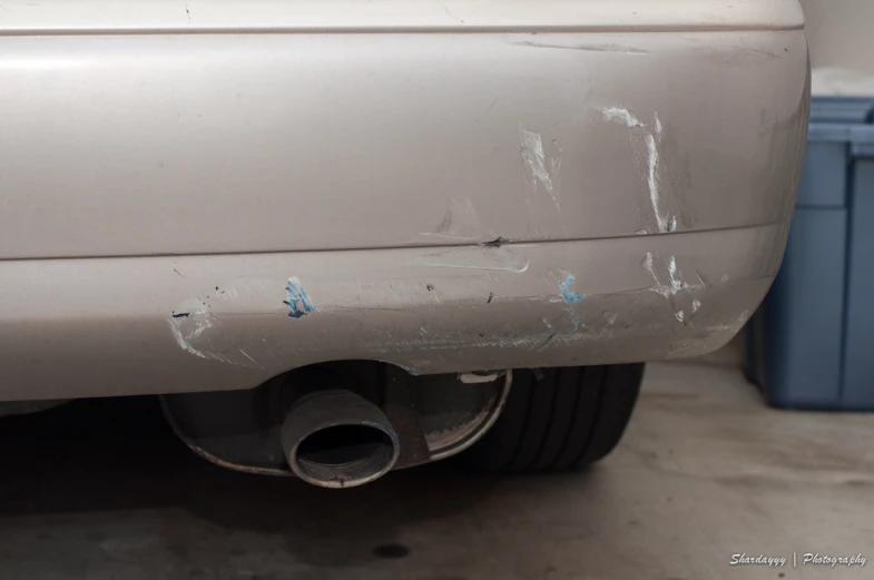 a car parked next to some trash can