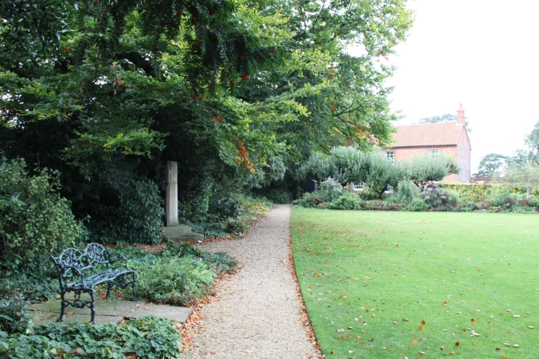 a path that leads into a house next to some trees