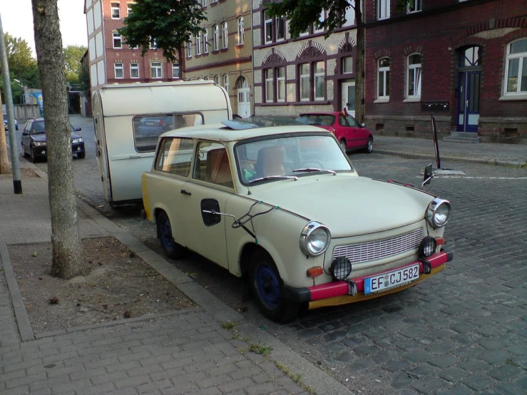 an old car parked on the side of the street