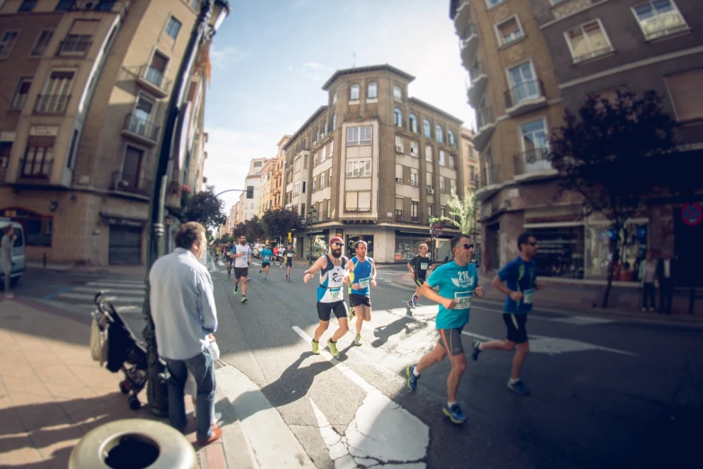 the group of men are crossing the street together