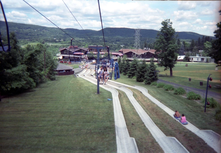 some people are riding on a chair lift