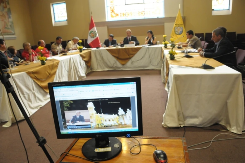 a group of people are sitting at tables looking around