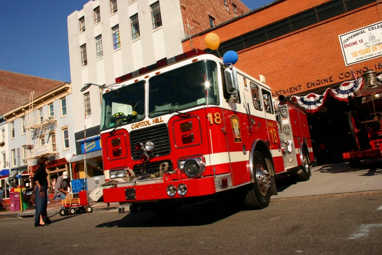 the fire engine is driving down the city street