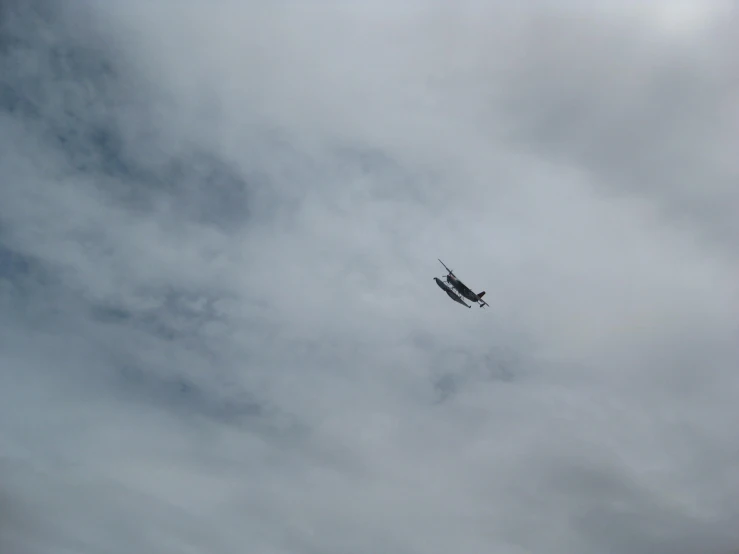 a plane flying in the sky with clouds