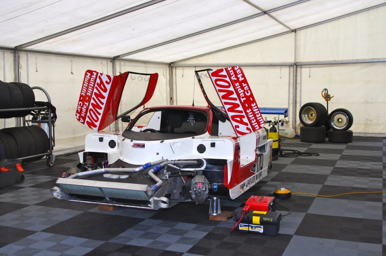 two large trucks with the front doors open and the back of the car partially dismantled