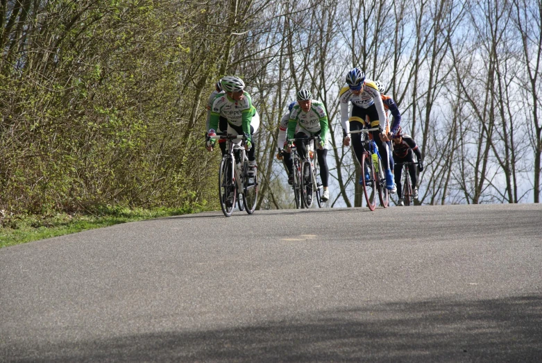 three people riding their bikes on the street