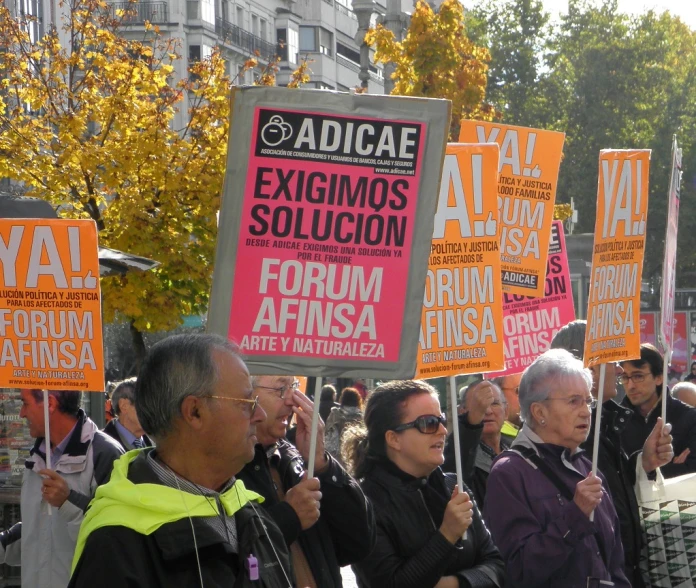 a large group of people standing together with signs