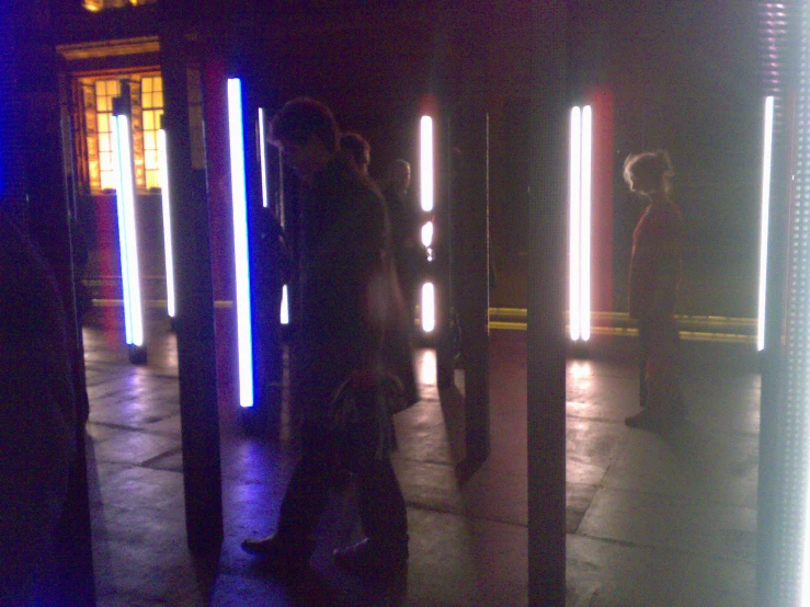 a view from the ground of people walking near a row of stalls