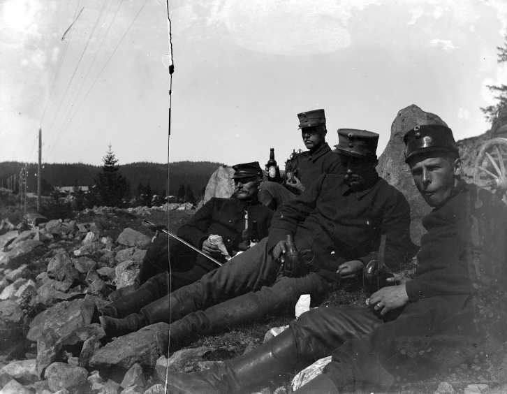 several soldiers are posing in a line near some rocks