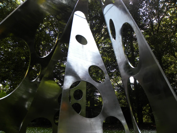 metal sculptures are arranged in an open area