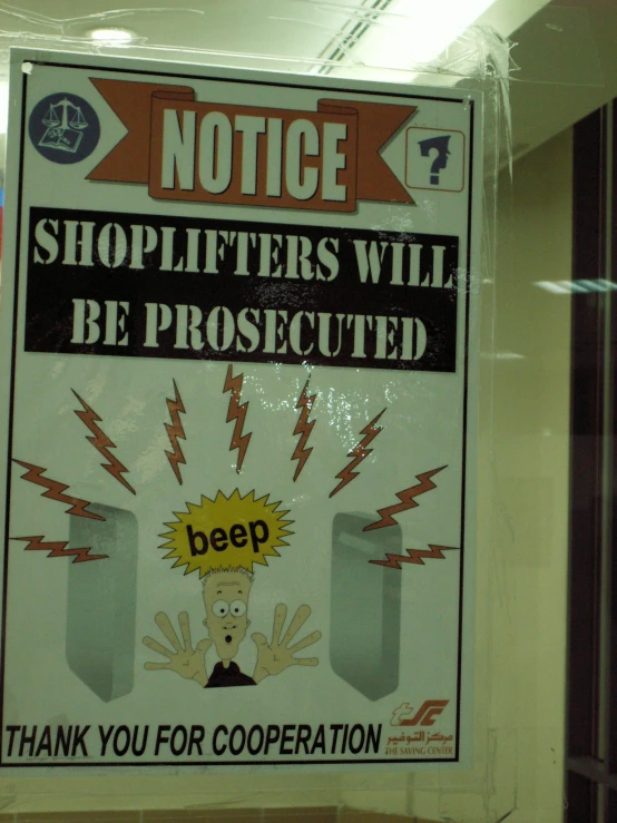 a sign that is advertising shoplifters will be protected by the door