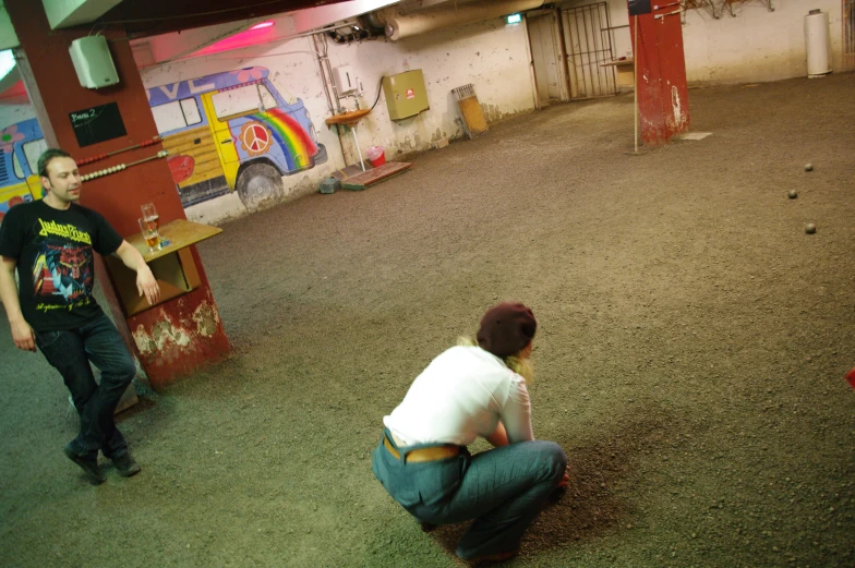 a man kneeling down and a woman holding his arm up