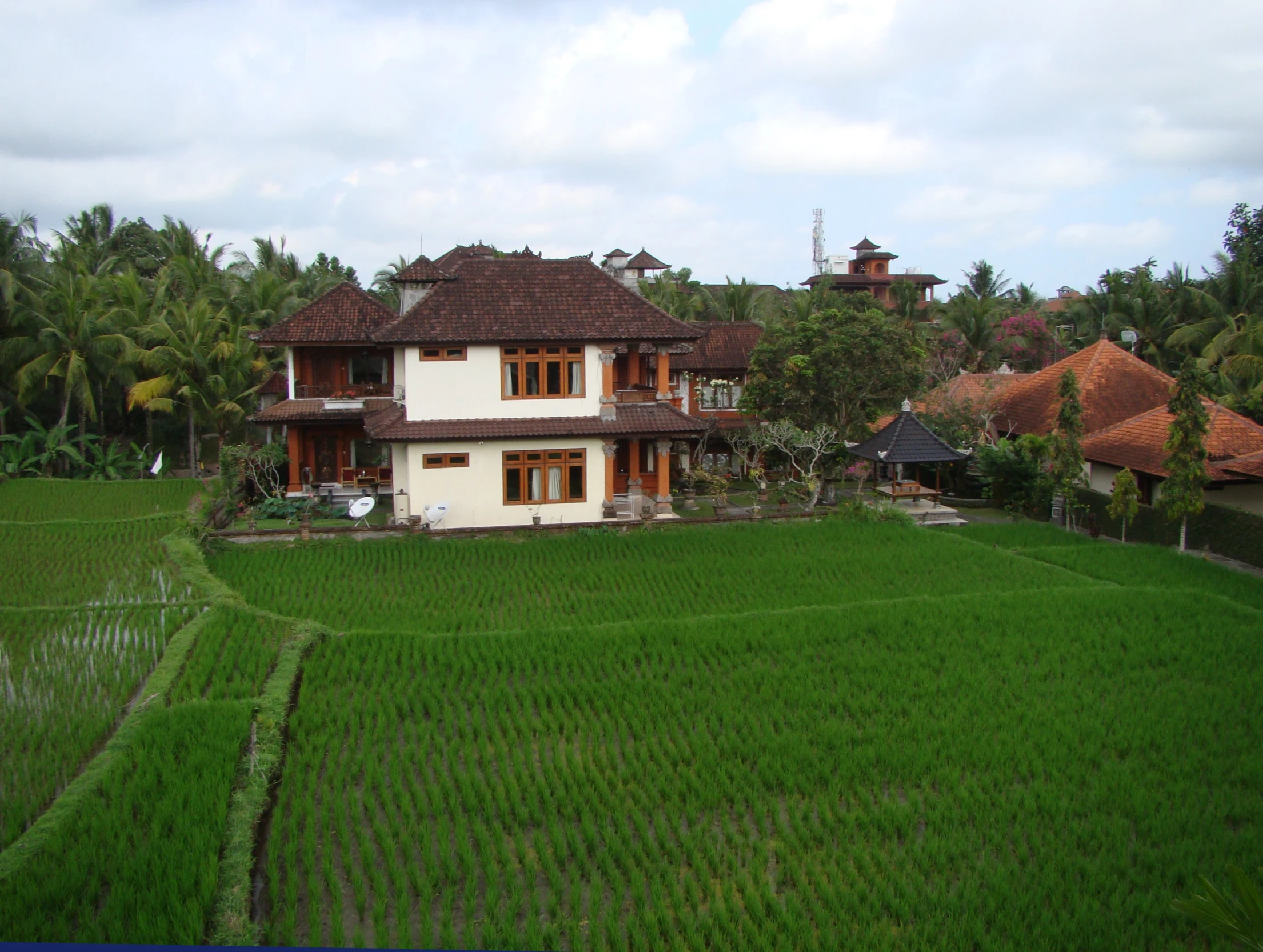 a large house on top of a lush green field