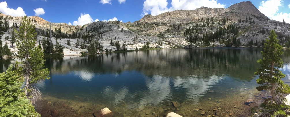 there is some water surrounded by rocks and a mountain