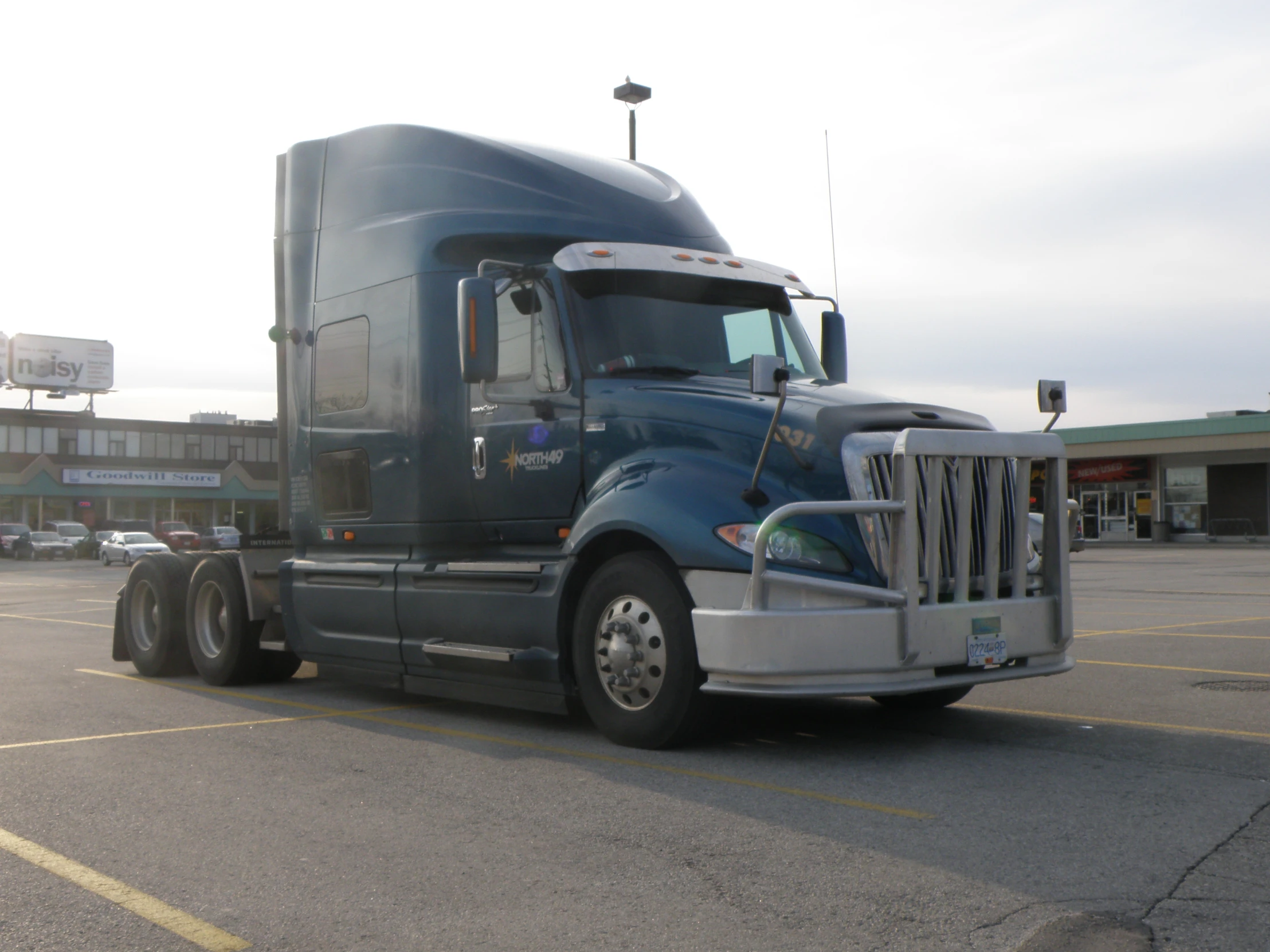 a large black semi truck parked in a parking lot