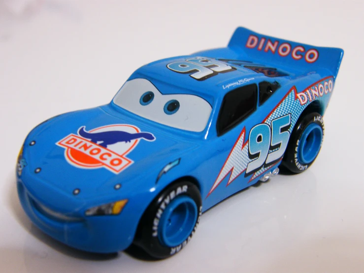 a blue toy car with a picture of characters