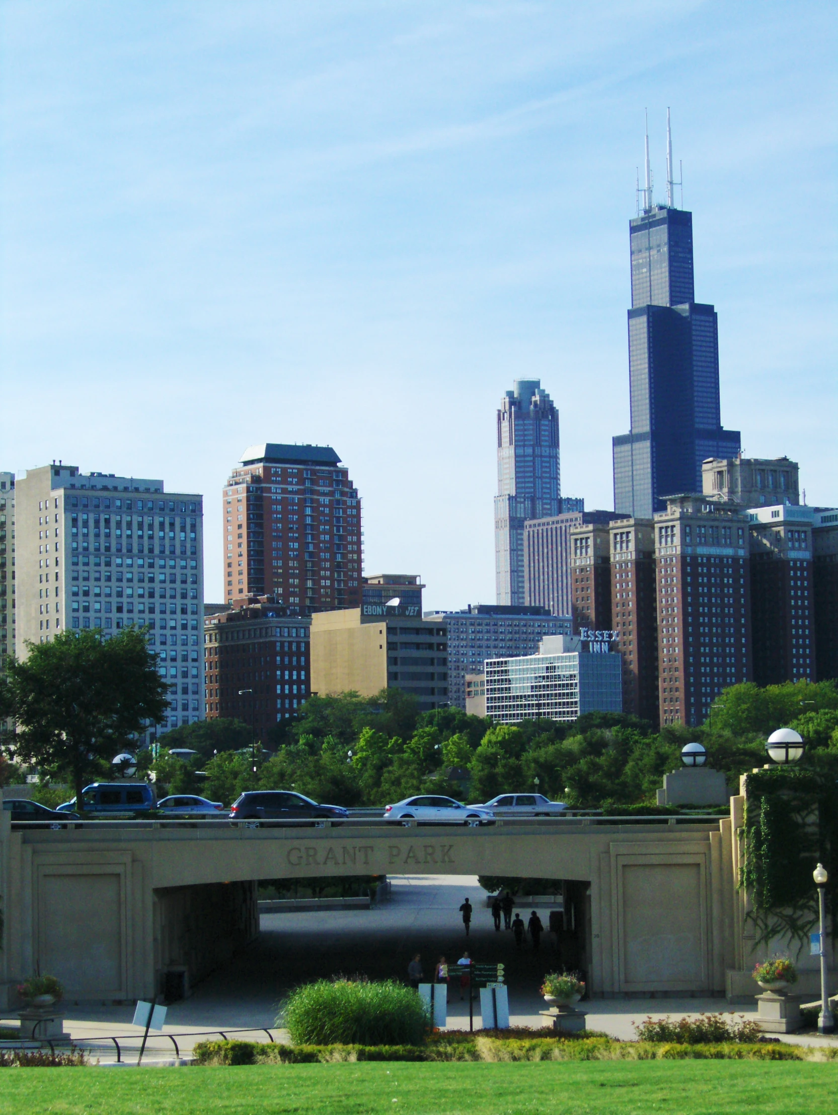 a cityscape with skyscrs, cars and a bridge