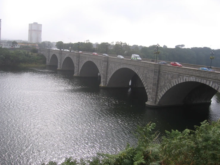 a bridge that has cars on it over some water