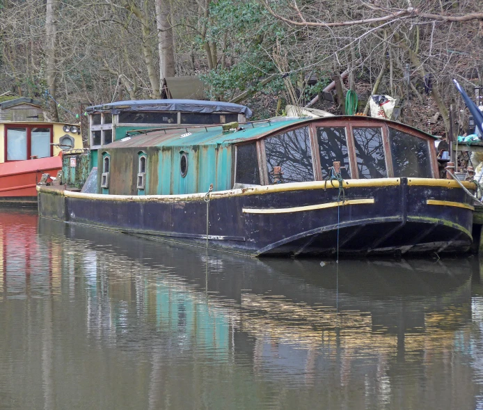 two house boats floating in a waterway in the woods