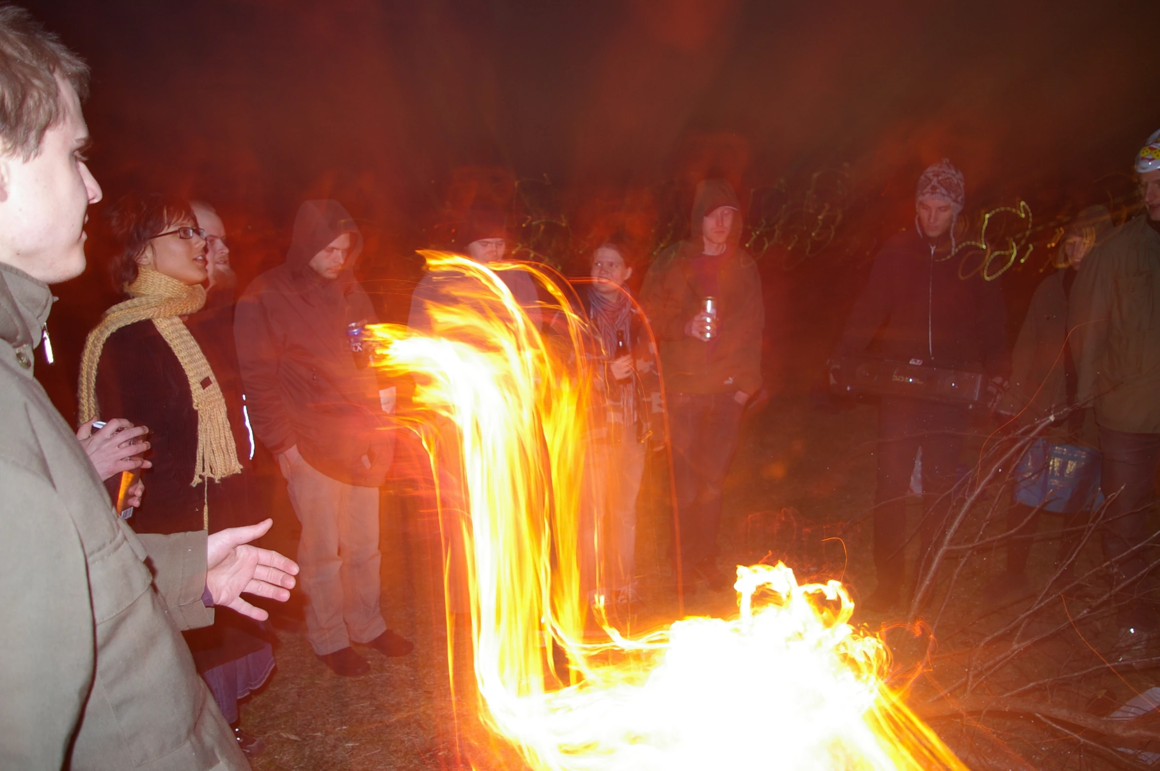 a group of people standing around a fire