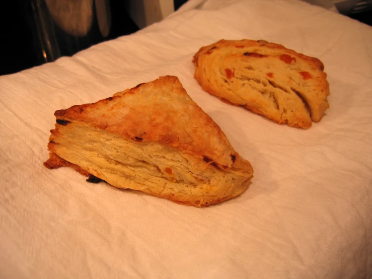 two pieces of bread sitting on a table