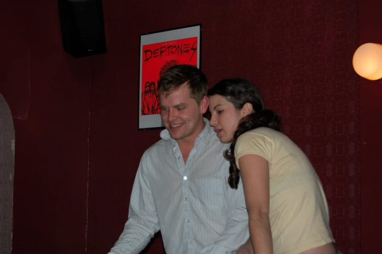 a man and woman are standing with each other at a table