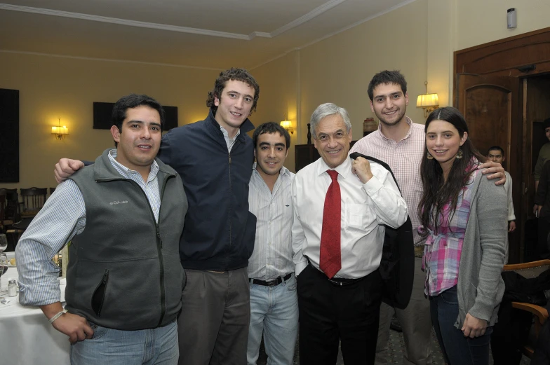 some friends posing for a group po in the middle of a banquet room