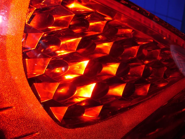 an illuminated tail light reflecting sunlight on it