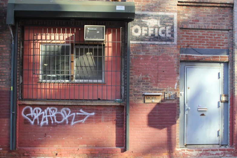 a door and window that has been tagged with graffiti