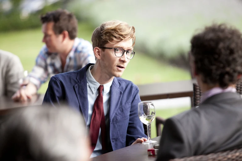 man sitting at table and looking off to his right