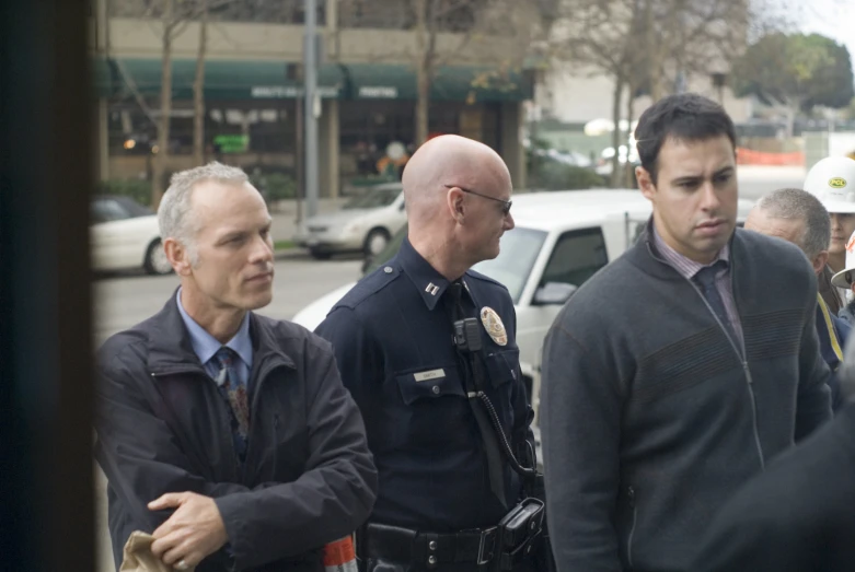 three police officers are talking to one another