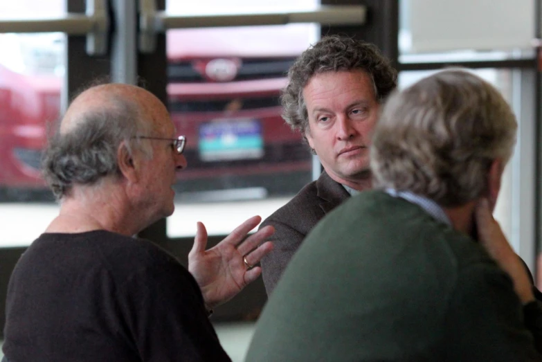 two men having conversation in a cafe