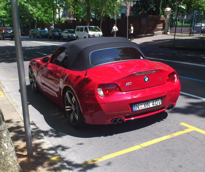 a convertible car on a city street with other vehicles