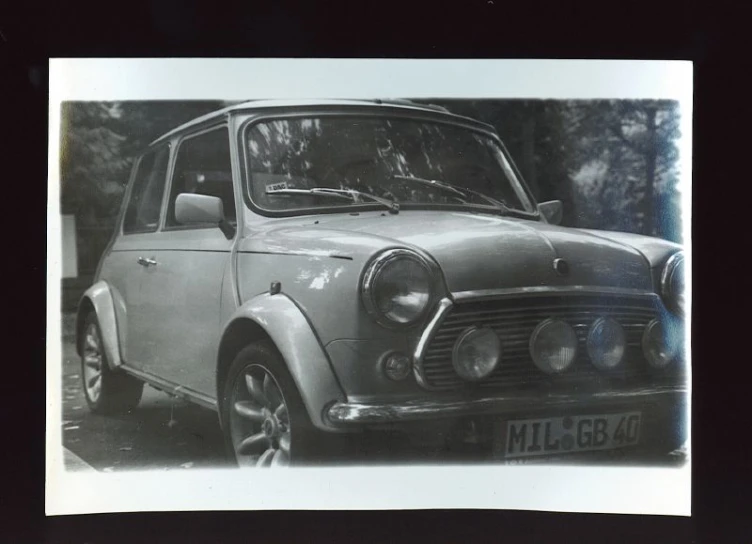 this black and white po shows an old style car