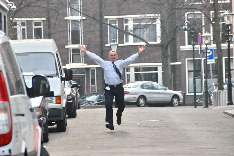 a man running in the middle of a busy street