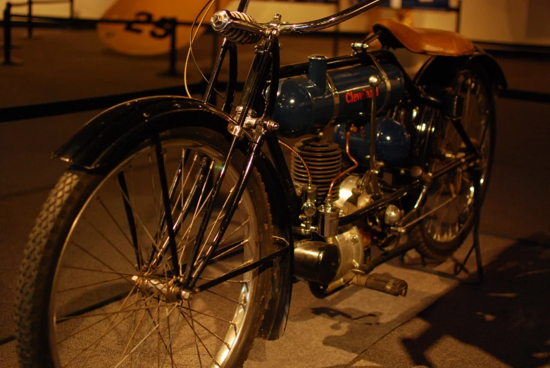 an old motorcycle sitting parked next to a building