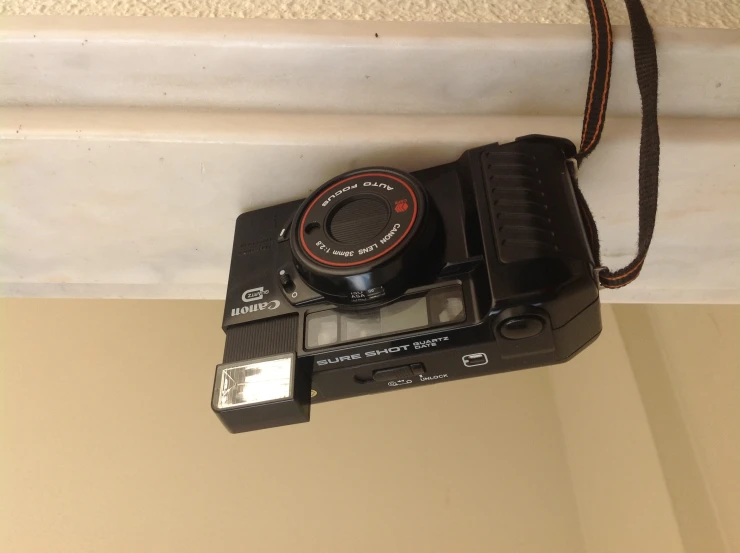 an old black camera sitting on top of a counter