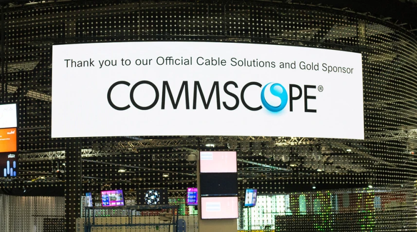 a large commsoe sign at a convention