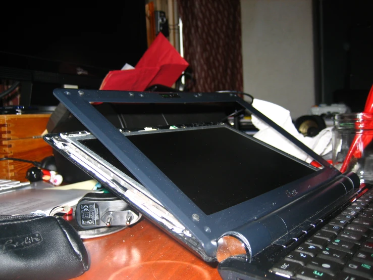 a computer with its screen open sitting on top of a desk