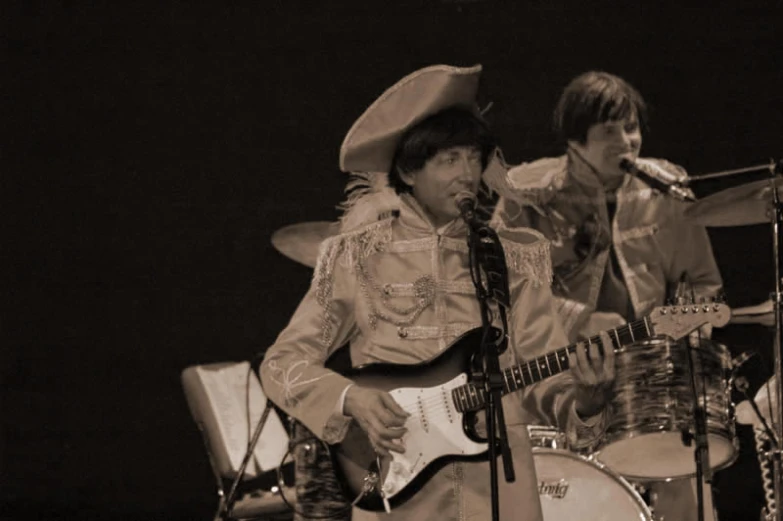 the singer and musician perform with instruments while the audience watches