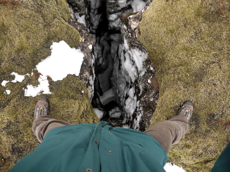 view down at someone's feet and a partially frozen pool