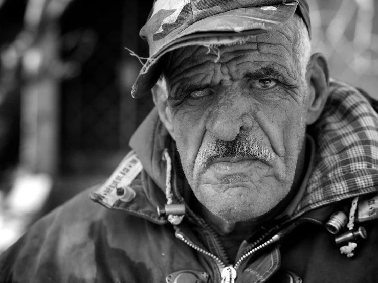 a man with a mustache and a hat with patches