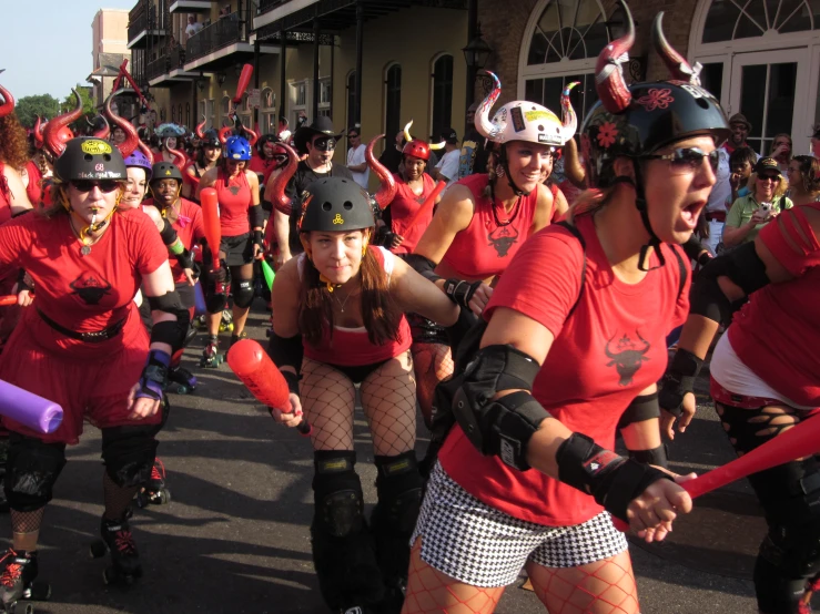 women with horns and stockings on roller skates in a parade