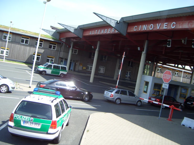 several police cars parked in front of a parking garage