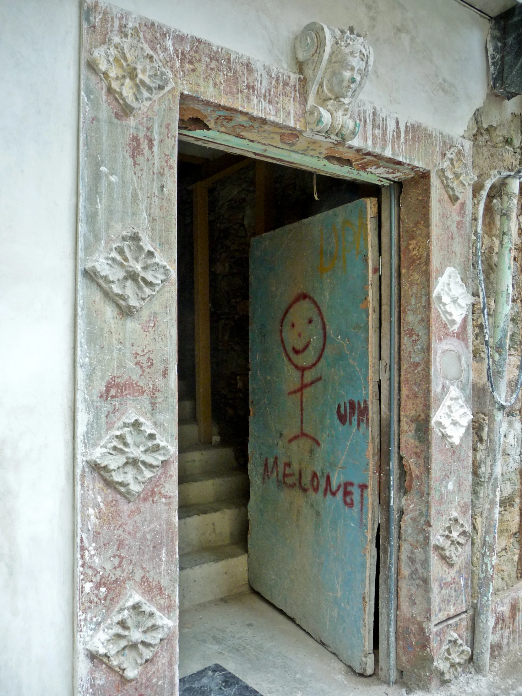 the doorway is covered in graffiti on some concrete