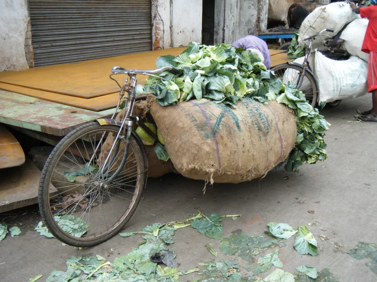 a person is hing a bike behind a huge object