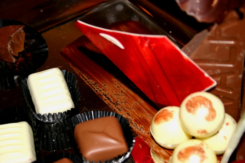 there is a box of chocolates with different colored candies on the table