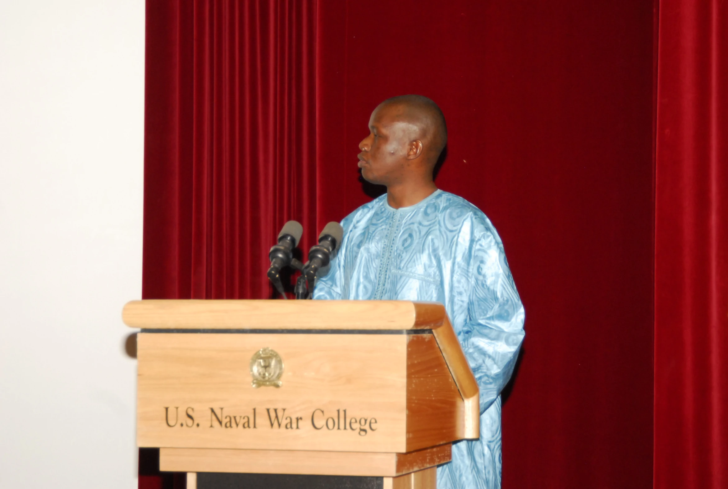 an african american man speaking at a podium