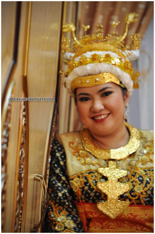 a woman with a gold headdress and ornate hair piece